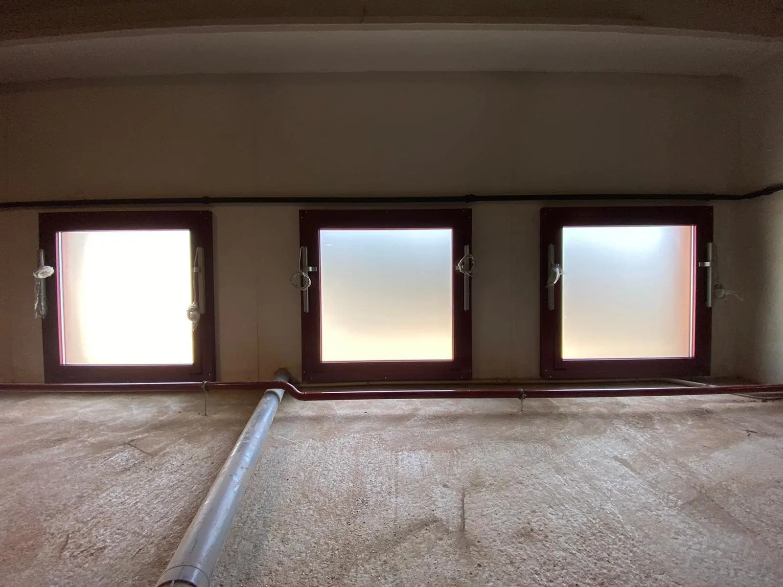3 exutorios de ventana cuadrados con el marco rojo, vistos desde dentro